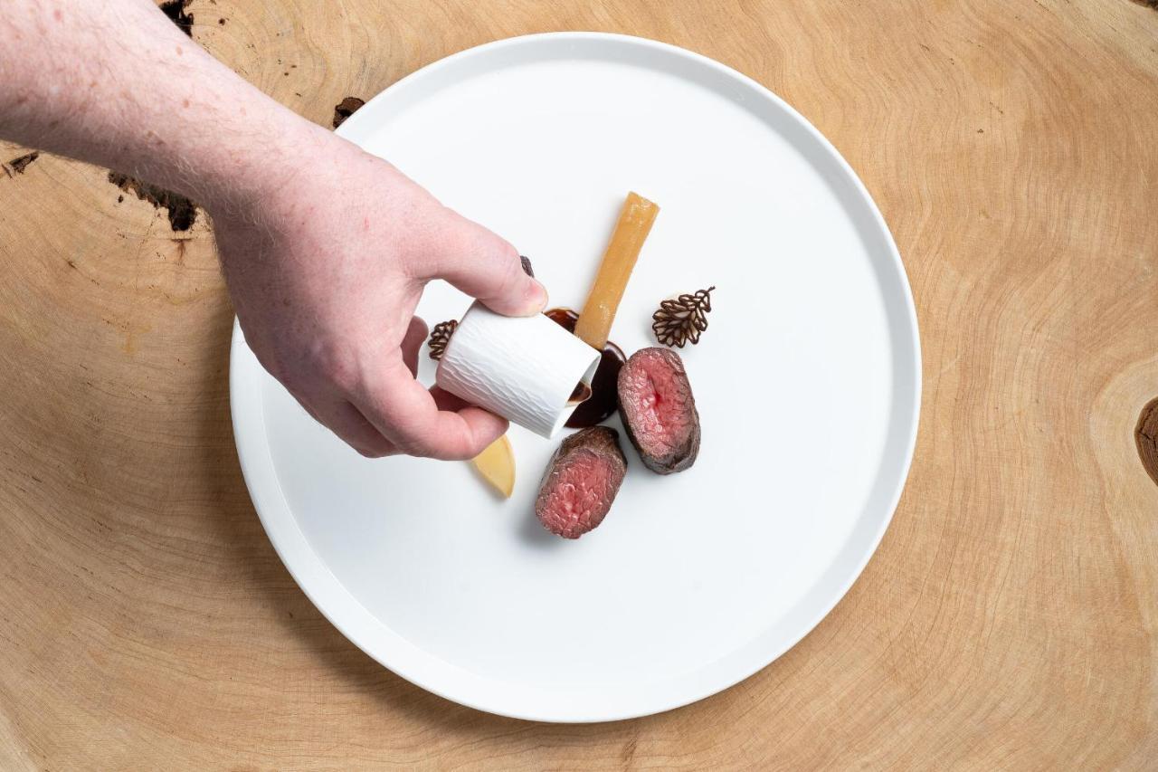 Boringdon Hall Hotel And Spa Плаймаут Экстерьер фото A hand seasoning a plate of food with a spice shaker